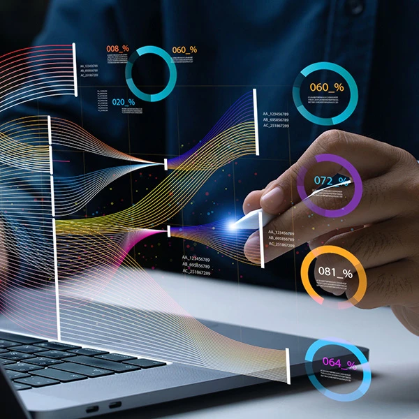 Person using a stylus to interact with a laptop displaying futuristic holographic data visualisations, including flowing lines, circular analytics, and digital growth charts.