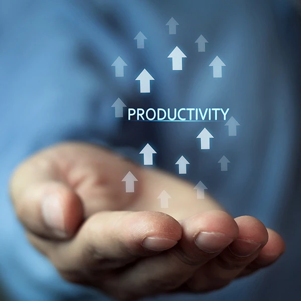 Close-up of a person’s open hand with the word “productivity” surrounded by upward-pointing arrows, symbolising growth, efficiency, and performance improvement.