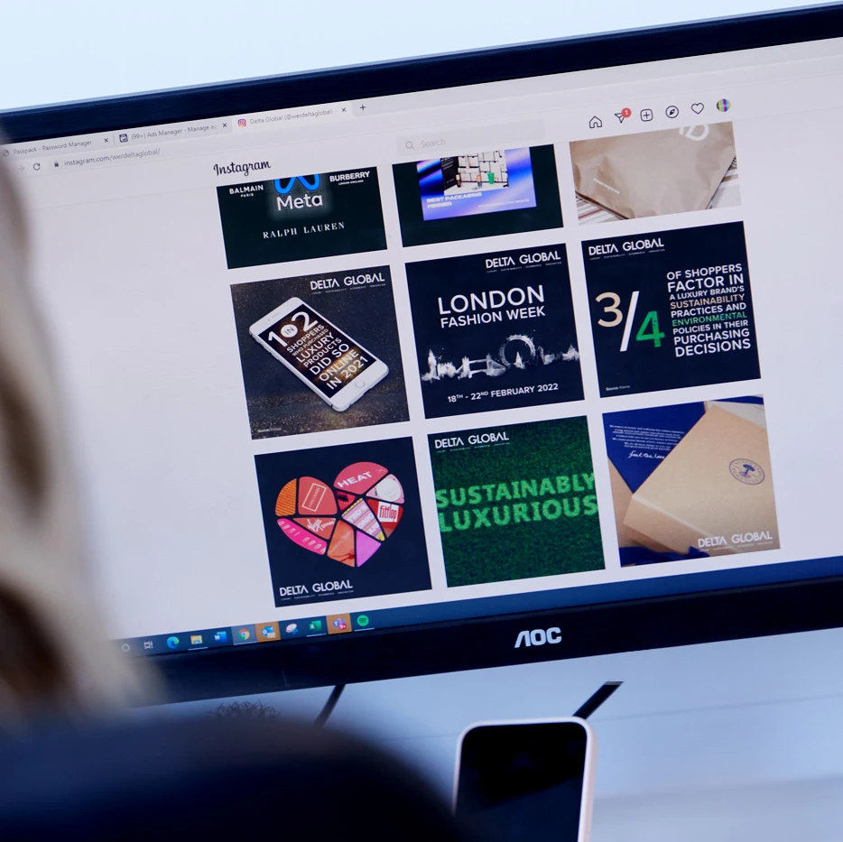 Person viewing Delta Global’s Instagram profile on a desktop computer screen, showing a grid of branded posts featuring luxury, sustainability, and fashion content.