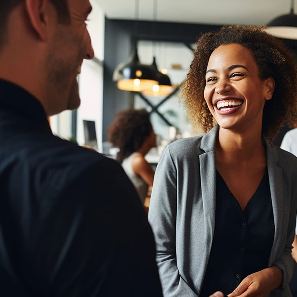Smiling colleagues chatting in a modern office reception area
